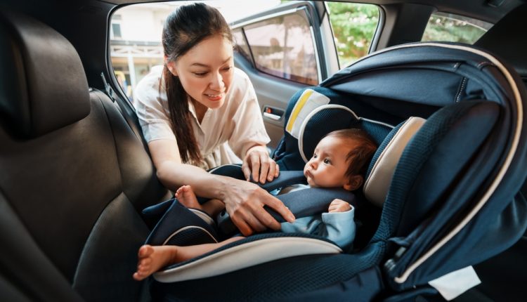 Happy,Mother,Is,Fastening,Safety,Belt,To,Newborn,Baby,In