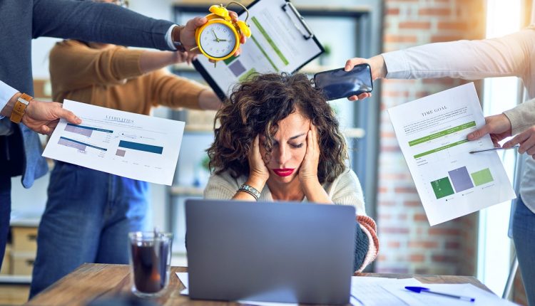 Group of business workers working together. Partners stressing one of them at the office